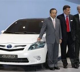 Shinichi Sasaki, Toyota's excecutive vice-president, Andrea Formica, senior vice-president for marketing of Toyota Europe, and the CEO of Toyota Motor Europe Tadashi Arashima, from left, shake hands next to a Toyota Auris HSD Full Hybrid concept car on the first press day of the Frankfurt Auto Show in Frankfurt, Germany, Tuesday, Sept. 15, 2009. The…
