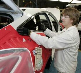 Sheryl Hirneise, a Honda associate, installs the rear side window during production of a 2010 Honda Crosstour at Honda's East Liberty Auto Plant in Ohio.