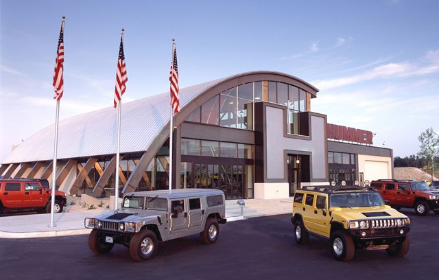 HUMMER dealership exterior. HUMMER dealers across the country are opening stand-alone facilities designed in this unique Quonset-hut style. The design was created by Pavlik Design, the architecture firm famous for retail environments in Neiman Marcus and Saks 5th Avenue. The facilities embody a military motif and are often fabricated from more than 138 tons of…
