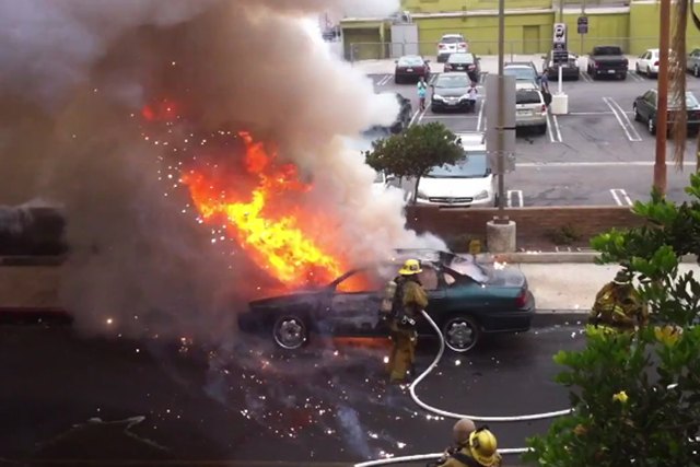 watch as a burning car explodes in a firefighter s face video