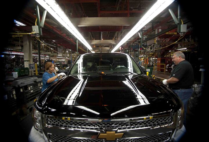 Eunice Marshall, left, and Michael Donahue inspect a truck as it comes to the end of the line.