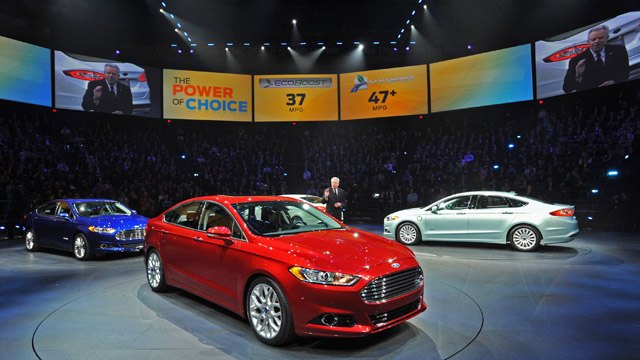 January 9, 2012 — Derrick Kuzak, Group Vice President, Global Product Development, Ford Motor Company speaks with journalists from around the world at the North American International Auto Show. Ford today introduced its new 2013 Ford Fusion, center, 2013 Ford Fusion Hybrid, left, and 2013 Fusion Energi Plug-in Hybrid. (01/09/12)