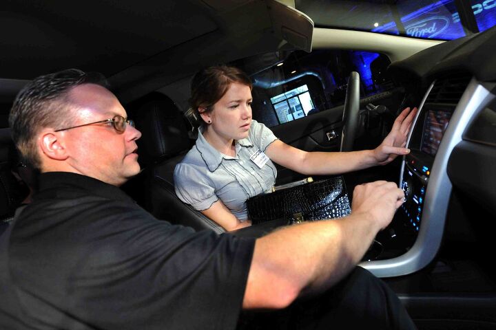 Nashville, TN, 8/17/2010. Approximately 100 automotive and tech media drove the 2011 Ford Edge and Ford Edge Sport for the first time in Nashville TN. Media also recieved hands on demos of the all new My Ford Touch. Shown here is Ford Engineer Jim Zaremski explaining Edge new technology to Journalist Hannah Elder. (08/23/2010)