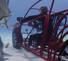 volkswagen beetle shark cage drives under water video
