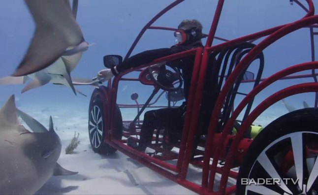 volkswagen beetle shark cage drives under water video