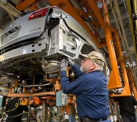 Greg Middleton, a GM employee for 28 years, marries the chassis to the body of a 2015 Buick Enclave Thursday, April 30, 2015 at the General Motors Lansing Delta Township Assembly plant where GM announced today it will invest $520 million for tooling and equipment for future new vehicle programs, retaining 1,900 jobs. The investment…