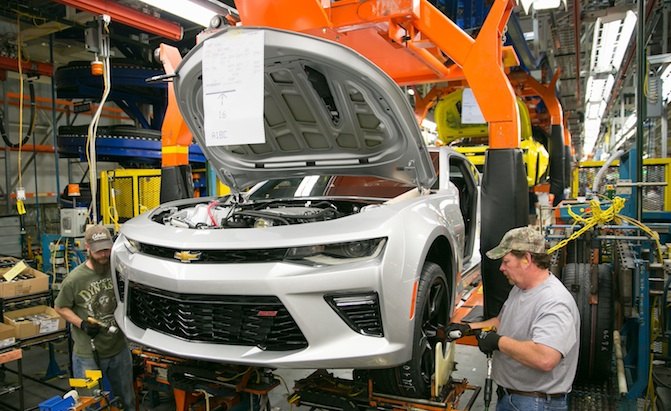 Larry Conarton, right, and Ben Spedoske install wheels and tires on a pre-production 2016 Chevrolet Camaro for testing Thursday, May 28, 2015 at the General Motors Lansing Grand River Assembly Plant in Lansing, Michigan, where GM announced today it will invest $175 million for new tooling and equipment to build the sixth-generation Chevrolet Camaro –…