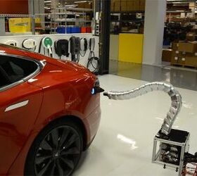 tesla shows off creepy automated charger prototype