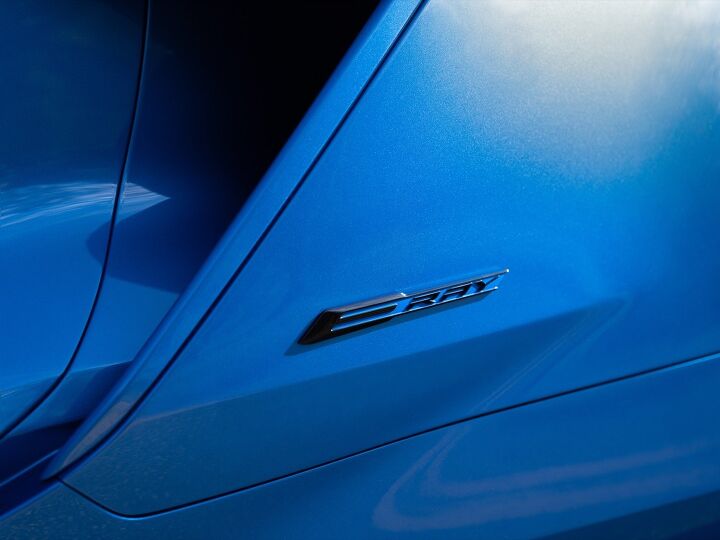 Close up view of E-Ray badge on 2024 Chevrolet Corvette E-Ray 3LZ coupe in Riptide Blue. Pre-production model shown. Actual production model may vary. Model year 2024 Corvette E-Ray available 2023.