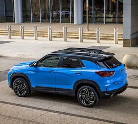 Rear 7/8 view of 2024 Chevrolet Trailblazer RS in Fountain Blue parked in front of a building. Preproduction model shown. Actual production model may vary. Available in fall 2023.