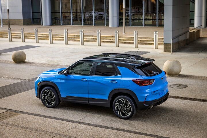 Rear 7/8 view of 2024 Chevrolet Trailblazer RS in Fountain Blue parked in front of a building. Preproduction model shown. Actual production model may vary. Available in fall 2023.