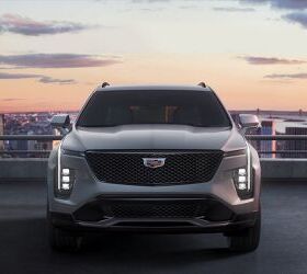 The front fascia of the 2024 Cadillac XT4 features the unmistakable Cadillac vertical light signature, sleek LED headlamps and a new grille design with a modern reinterpretation of the classic Cadillac chevron. Shown here in Argent Silver Sport.