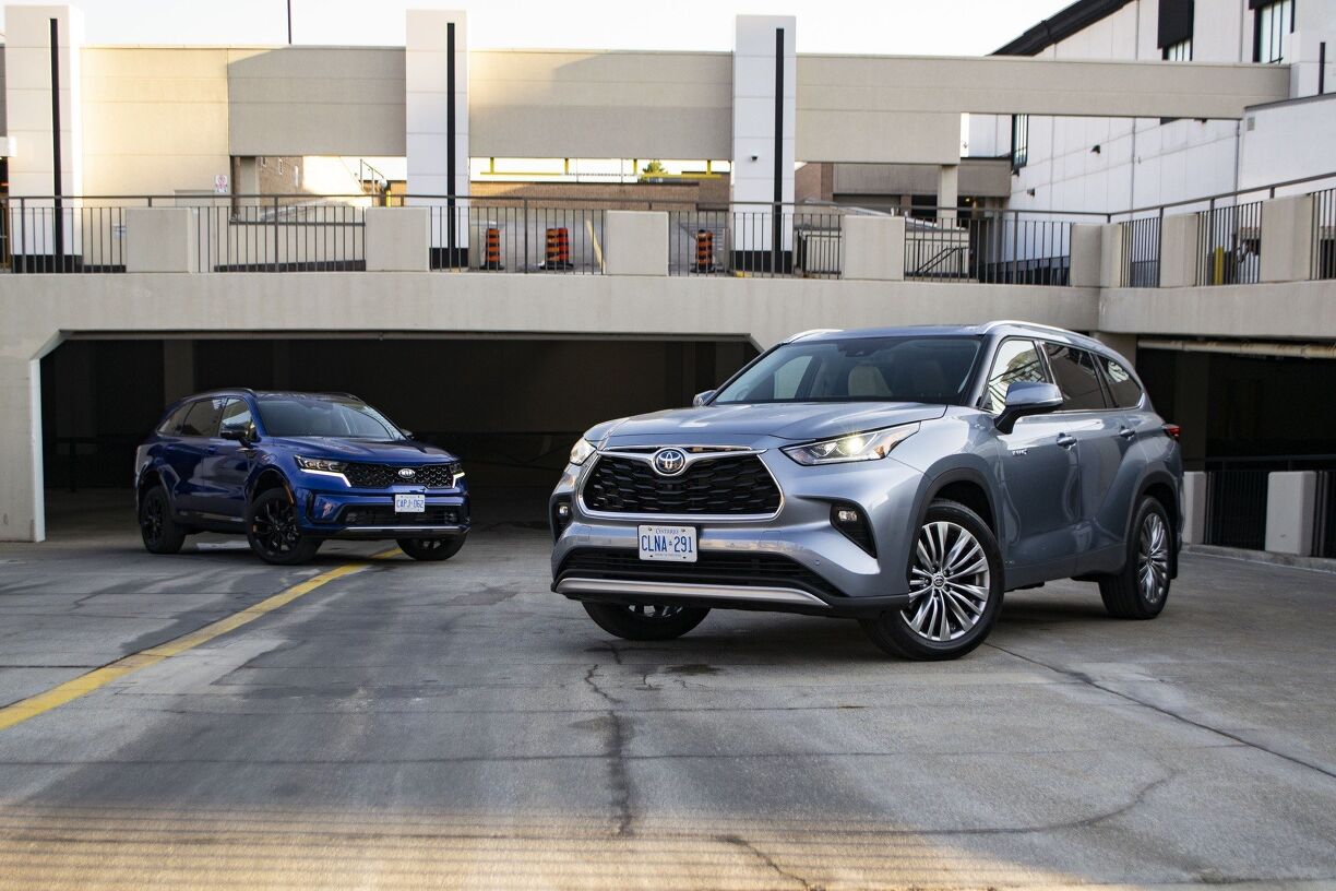 Interior comparison of Kia Sorento Hybrid and Toyota Highlander Hybrid cabins, showcasing design and technology differences