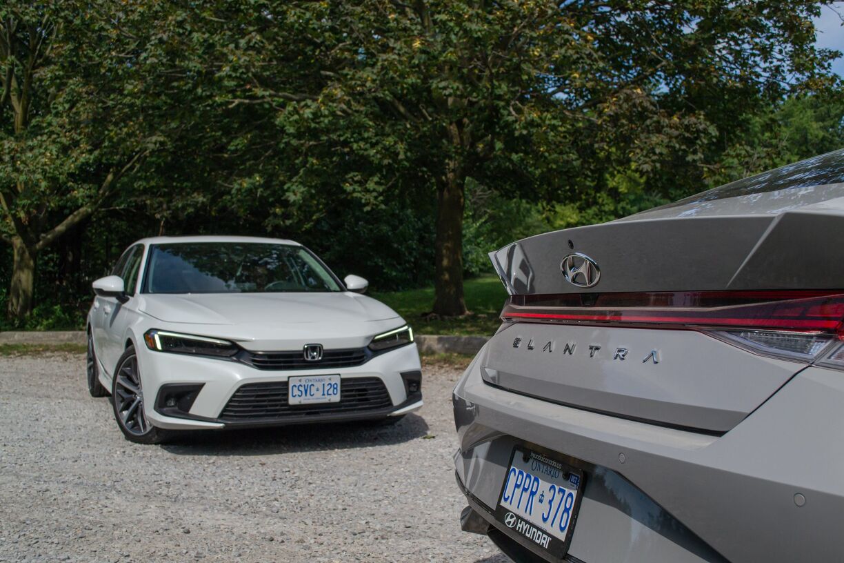 Side-by-side comparison of the 2026 Hyundai Elantra and Honda Civic, showcasing their sleek, aerodynamic profiles.