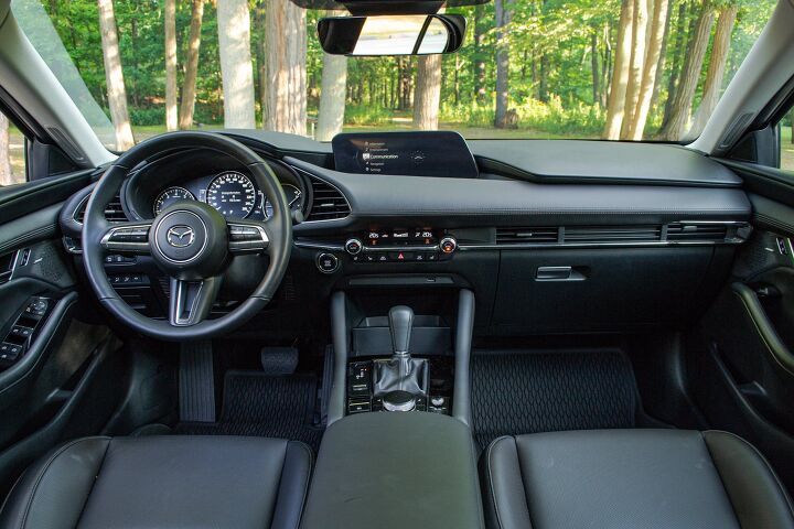 Comparison of Honda Civic and Mazda3 interiors showing overall layout and design differences