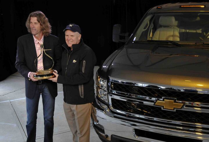 Motor Trend Editor in Chief Angus MacKenzie (left) presents the Motor Trend Truck of the Year trophy to General Motors CEO Dan Akerson for the 2011 Chevrolet Silverado HD Dually pickup Saturday, December 11, 2010 prior to the Army-Navy football game in Philadelphia, Pennsylvania. (Photo by Janette McVey for Chevrolet)