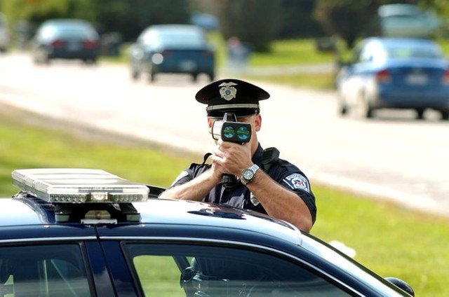 Pittsfield Township police officer Brian Kabat uses his radar gun to check for potential speeding violations on Golfside Road between Ellsworth and Packard, Thursday afternoon, September 10th. Lon Horwedel | Ann Arbor.com