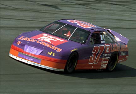 Driver John Andretti, from Indianapolis, Ind., takes a Lincoln Mark VIII around the Charlotte Motor Speedway in Concord, N.C., Wednesday, May 8, 1996 during open testing at the track. The new Lincoln is being tested by  Kranefuss-Haas Racing for approval by NASCAR for Winston Cup competition.(AP Photo/Chuck Burton)