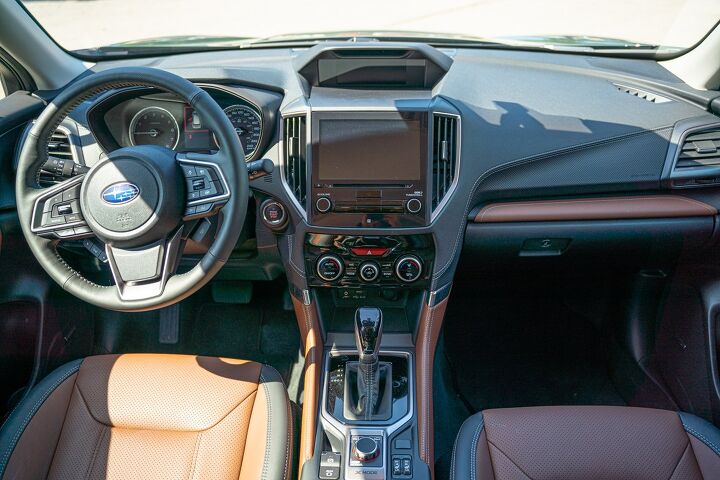 Subaru combines a simple interior with a steering wheel that's almost overloaded with buttons. The brown leather on this green model stands out as particularly appealing.