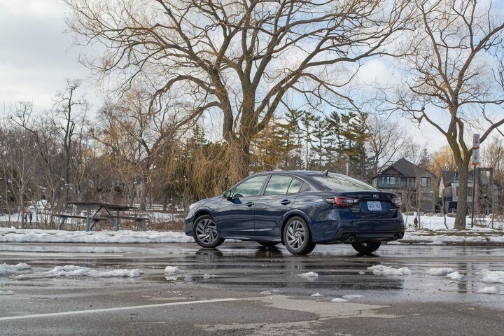 Subaru Legacy navigating snowy roads in a winter setting