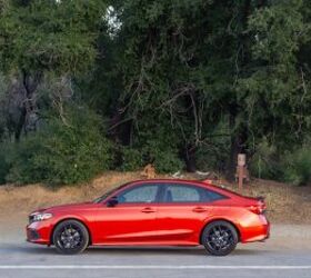 Side profile of the 2023 Honda Civic Si in Rallye Red with 18-inch matte black alloy wheels wrapped in 235/40R18 tires.