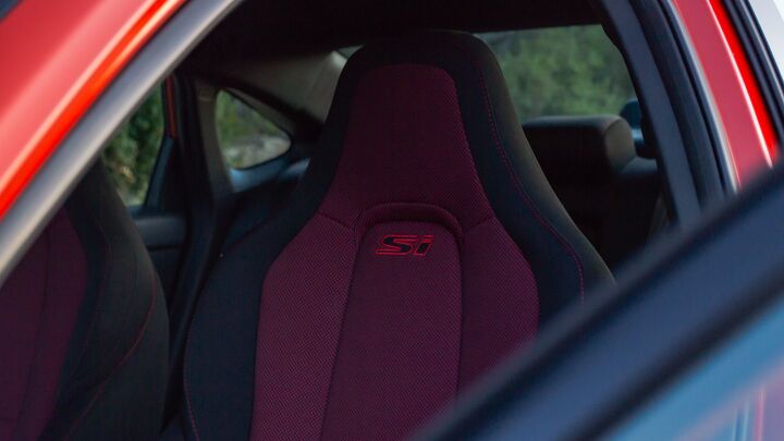 Unique to the Si model are custom sporty seats with a black and red treatment. They include "Si" stitching just below the headrest.