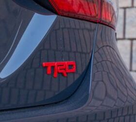 The bright red TRD badging pops agains the Camry TRD's "Underground" paint color.