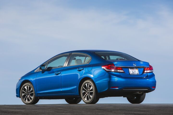 Rear angle of the 2015 Honda Civic Sedan in Driving shot of the its unique Dyno Blue Pearl paint color