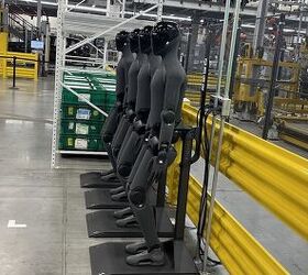 A collection of Figure 3 autonomous robots at their docking stations inside BMW's Plant Spartanburg in South Carolina.